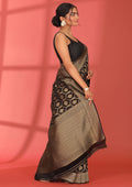 full length left view image of Taashi's The Midnight Archive Saree - VSTBSW03 | a premium black satin banarasi saree with gold zari brocade on body and dense zari jaal border and pallu